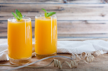 Healthy pumpkin fruit smoothie with  mint leaves on  table.