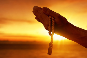 Hands of muslim man praying with rosary beads