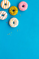 Traditional american donuts of different flavors on blue background flat lay mockup