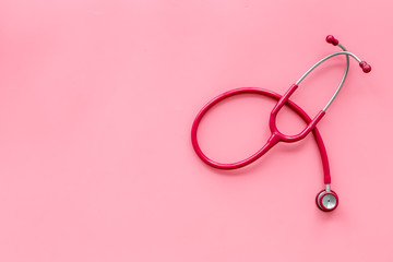 Fototapeta premium Stethoscope for family doctor set on pink background top view space for text
