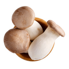 Pleurotus eryngii, king oyster mushrooms, king trumpets. Fresh raw edible  mushrooms in wooden bowl isolated on white. Top view.