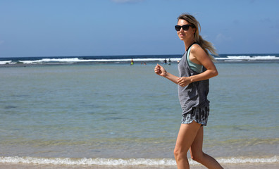 Happy woman running on seacoast. Sport, fitness people,stay fit on vacation concept