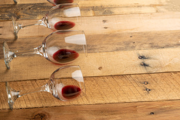 Red wine in transparent wine glasses on a wooden background. Bojole nouveau, wine bar, winery, winemaking, wine tasting concept, Flat lay