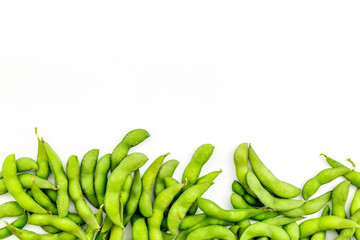 vegan food with green soybeans or edamame on white background top view