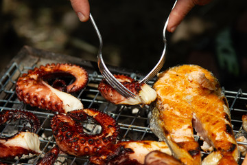 cooking fresh grilled octopus and fish