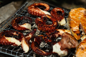 cooking fresh grilled octopus and fish