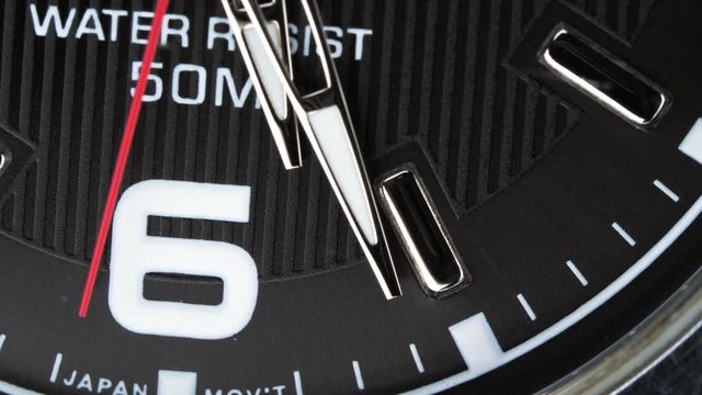 The movement of the hands of a quartz wrist watch. Close up. Business concept and time limit. The hand points to nine o'clock.