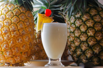 The Pina Colada is a sweet cocktail made with rum, coconut cream or coconut milk, and pineapple juice. It may be garnished with either a pineapple wedge, maraschino cherry, or both.