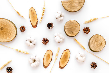 wooden stumps, immortelle and pine cones for blog background top view pattern