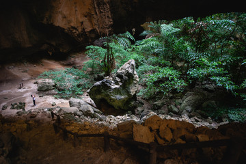 Woman standing in Phraya Nakorn cave.