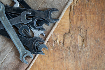 set of wrenches. Focus the set of tools in the workshop. Keys located on the background of the old table