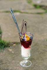 Berries with whipped cream in a beautiful cup.