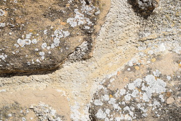 old brown stone wall texture with white spots
