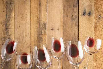 Red wine in transparent wine glasses on a wooden background. Bojole nouveau, wine bar, winery,...