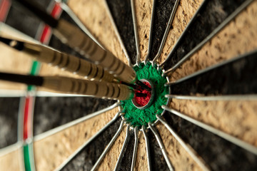 A perfect grouping and score in darts, with all three darts hitting the cherry.