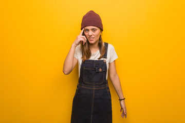 Young hipster woman doing a disappointment gesture with finger