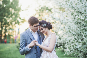 Tender portrait of the bride and groom in the spring park