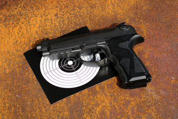 Black air gun with target on the metal grunge background.