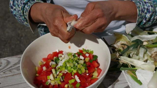 woman mixing ingredients for homemade tabbouleh