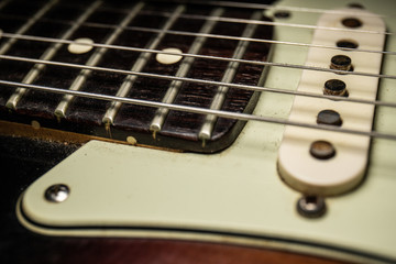 Details of electric guitar with macro dark background