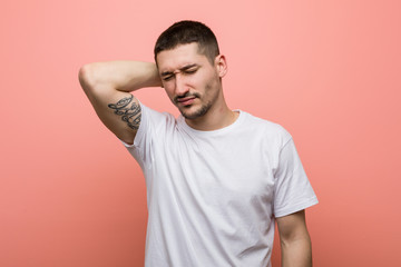 Obraz premium Young casual man suffering neck pain due to sedentary lifestyle.