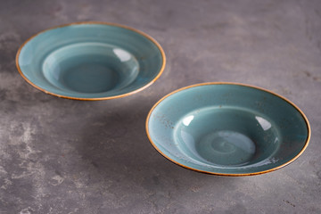 Two blue empty clay plates staying at table