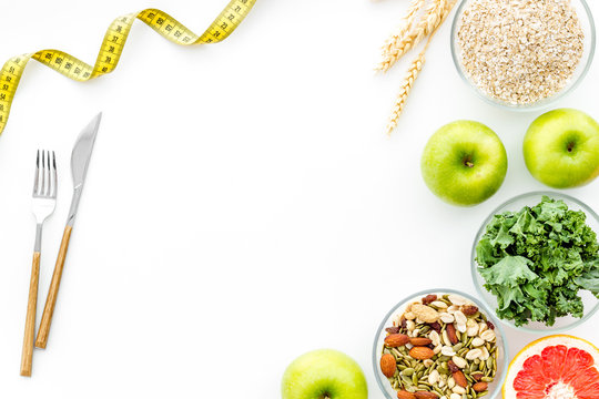 Weight loss concept with green organic food on white background top view space for text