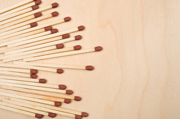 Matchsticks in a row on wooden table.