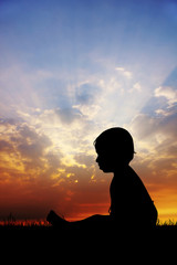 child in the meadow at sunset