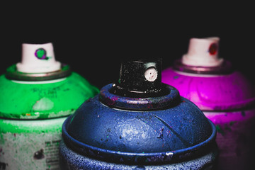 Paint spray for street art raw material for artistic work with black background. Macro and detailed...