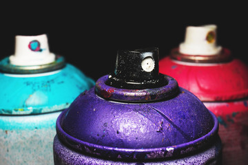 Paint spray for street art raw material for artistic work with black background. Macro and detailed...