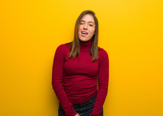 Obraz premium Young intellectual woman winking, funny, friendly and carefree gesture