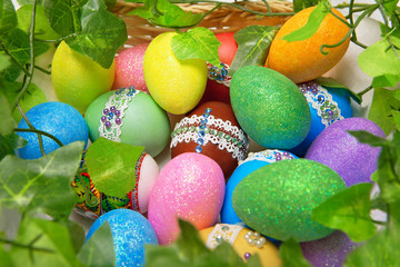 Colorful Easter eggs framed by a green plant.