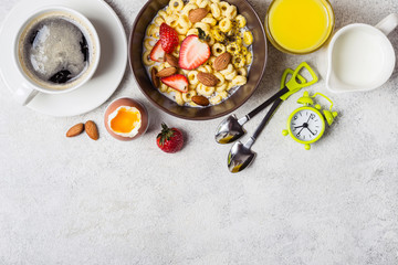 Healthy breakfast concept. Whole grain rings cheerios, coffee, orange juice and egg