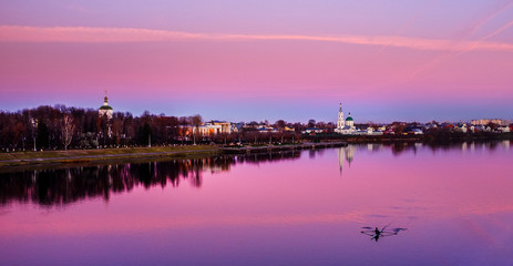 Solitary evening row on the Volga river in the Russian town of Tver as the sunset turns both the sky and the water into a magnificent purple.