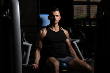 Fototapeta na wymiar Bodybuilder Doing Heavy Weight Exercise For Biceps