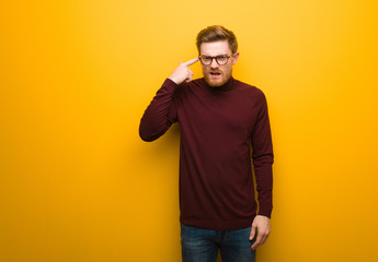 Fototapeta premium Young smart man doing a disappointment gesture with finger