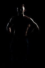 Fototapeta na wymiar Siluet Muscular Bodybuilder Flexing Muscles