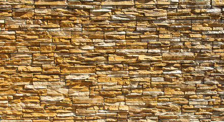 horizontal wall made of uneven stones in light colors often used as a decor
