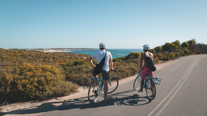 Friends stopping thei bikes to admire the ocean view