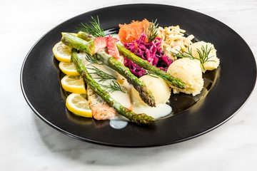 Grilled salmon with asparagus and potatoes, restaurant serving portion
