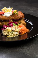 Potato pancake with meat and salad, restaurant dish