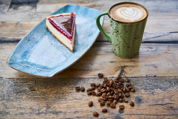 Coffee, coffee beans and cheesecake on a table