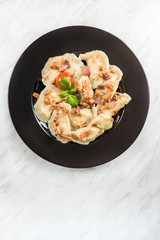 Traditinal Polish meat dumplings, served on plate in restaurant