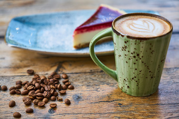 Coffee, coffee beans and cheesecake on a table