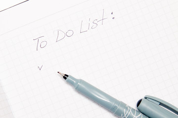 text to do list written on opened notebook, sketchbook. Flat lay, top view office table desk. Freelancer working place.