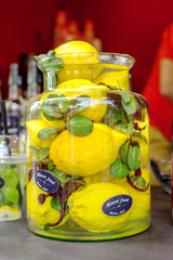 Glass bottle of water, mint leaves and lemons, infused water