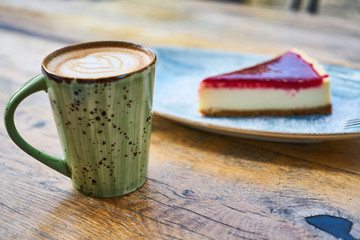 Latte coffee and cheesecake on a table