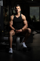 Fototapeta na wymiar Portrait Of A Handsome Man Resting At Gym