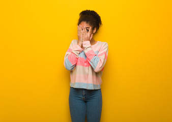 Young black african american girl with blue eyes feels worried and scared